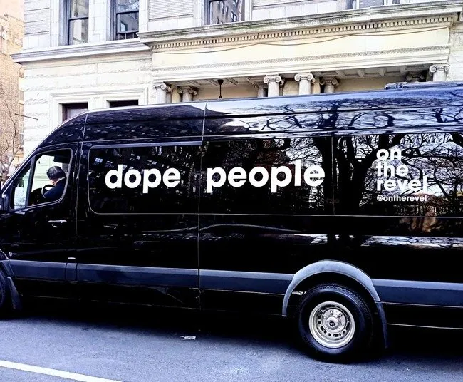 Cut Vinyl Lettering on a black van driving down the street in NYC