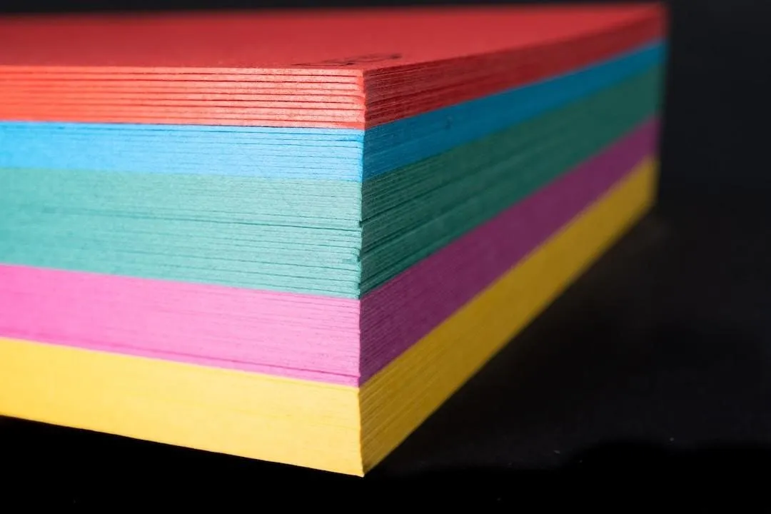 A stack of paper in various colors.