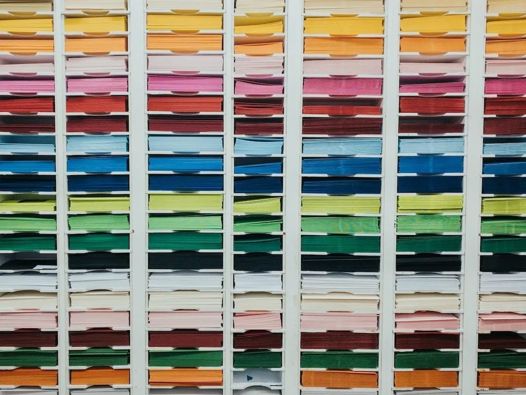 Rows of paper are separated and organized according to paper thickness and color.