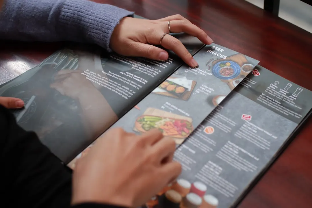 A customer peruses a folded menu that utilizes bleed printing.